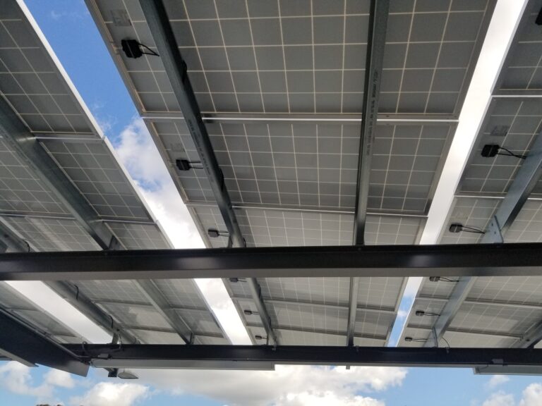 View from below of panels on a solar carport under a blue sky at a parking structure in Walnut Creek, California, March 8, 2019. Credit: Smith Collection/Gado/Getty Images