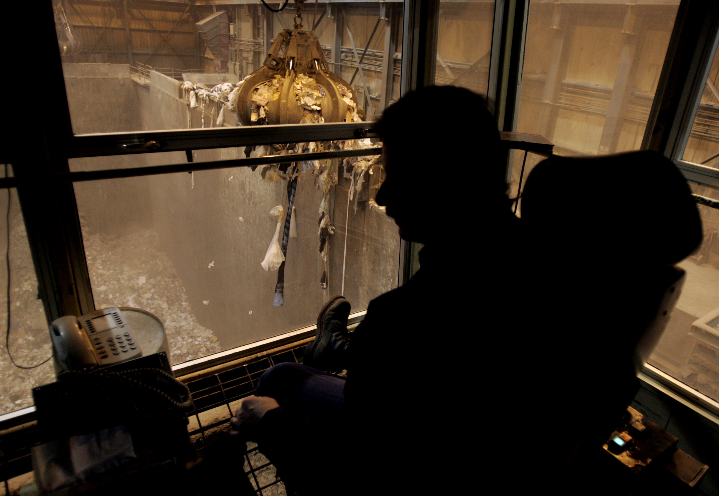 A crane operator sifts through mounds of garbage at the Hennepin Energy Recovery Center in Minneapolis, Minnesota. The trash is burned and used to generate electricity. Credit: Jerry Holt/Star Tribune via Getty Images