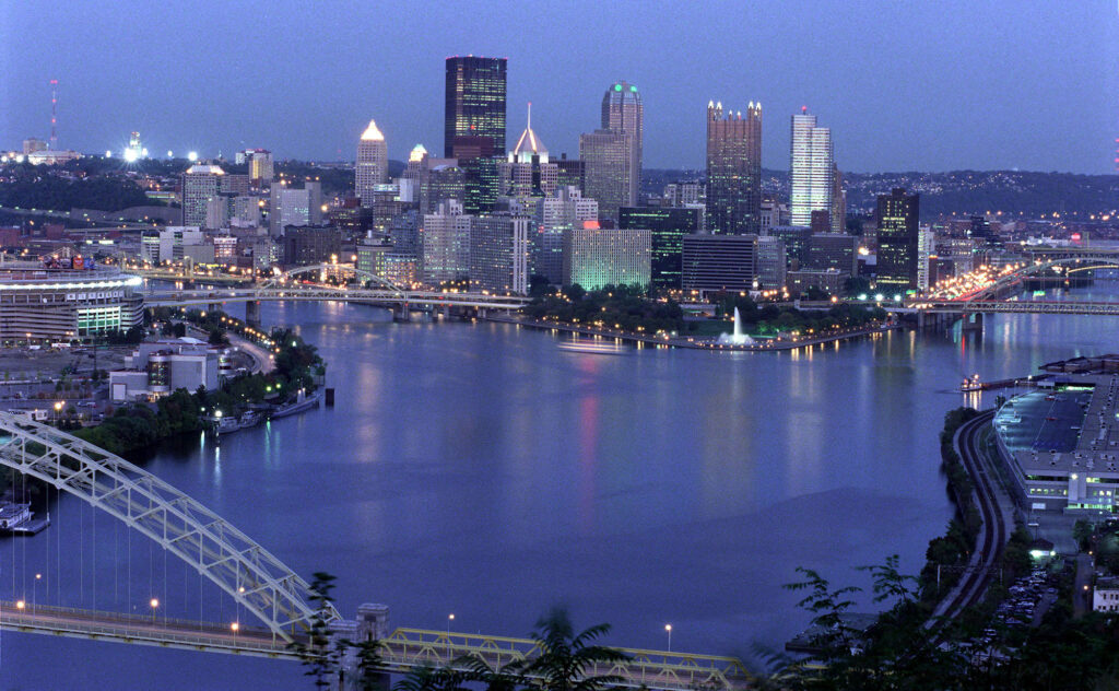 View of the downtown Pittsburgh skyline at dusk, showing the Allegheny and Monongahela rivers joining to form the Ohio River. Credit: Steven Adams/Getty Images