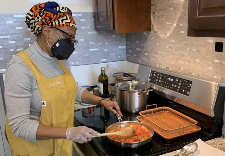 Chef Sia demonstrates how to use an induction stove during a cooking lesson at the office of the Association for Energy Affordability in the Bronx. Photo Courtesy of WE ACT for Environmental Justice