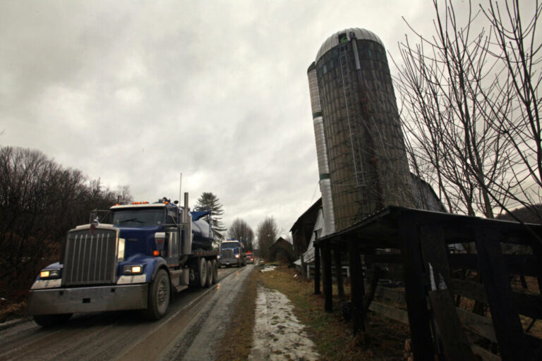 Three trucks go past a farm near Dimock, Pennsylvania. Credit: Carolyn Cole/Los Angeles Times via Getty Images