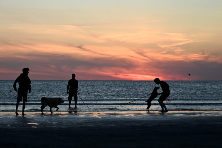 People enjoy the sunset on the beach of North Sea near the village of Lakolk, Denmark, on Sept. 3, 2022. Credit: Sergei Gapon/Anadolu Agency via Getty Images