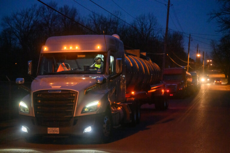 Trucks line up on a residential street one block from the Norfolk Southern train derailment in East Palestine, Ohio. The residual waste was transported from Ohio to Texas. Credit: Rebecca Kiger for The Washington Post via Getty Images