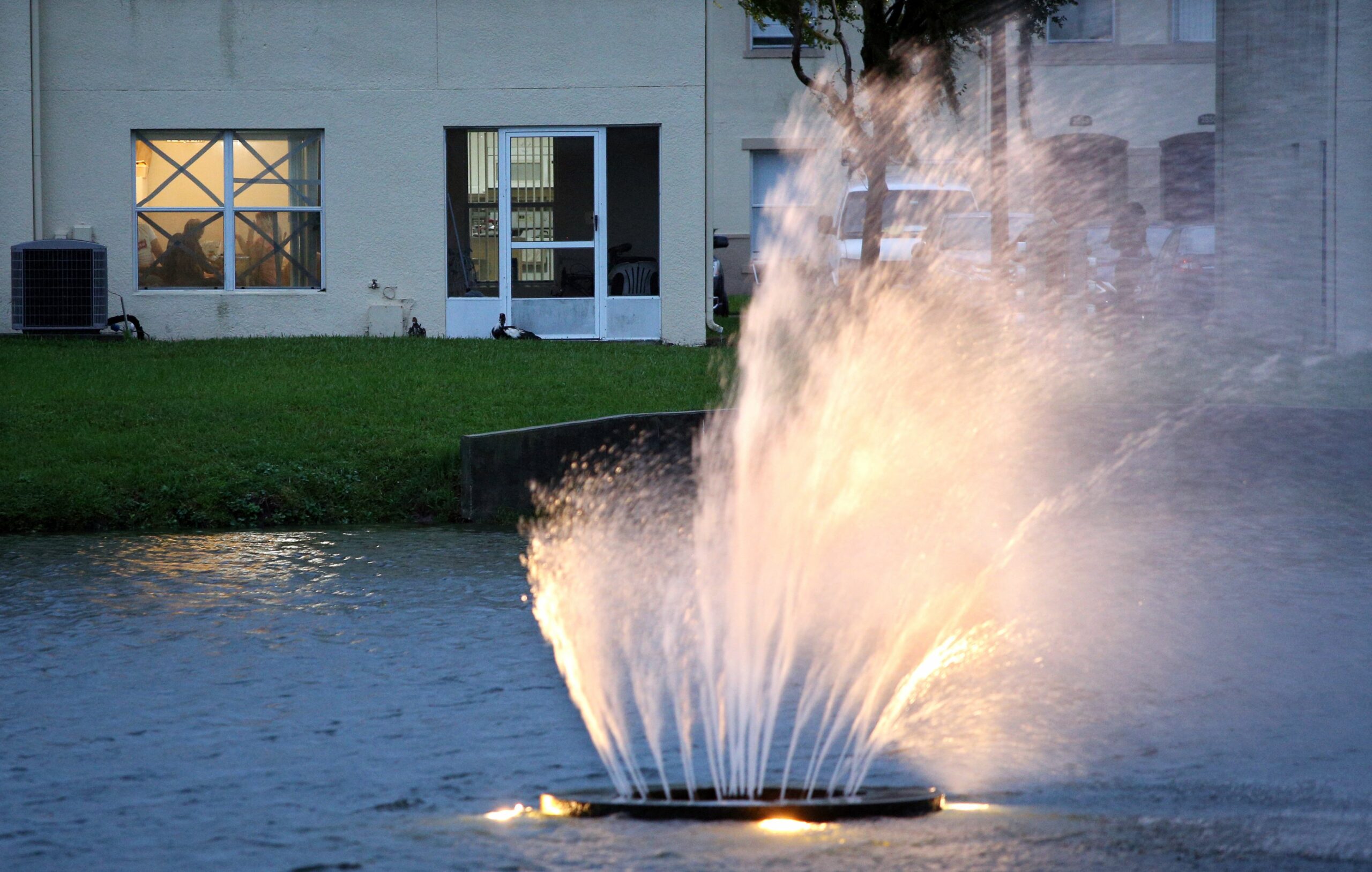 A fountain inside a condominium blows almost horizontal as residents tape their windows for alleged security, south of Orlando, on September 28, 2022. Hurricane Ian slammed into the coast of southwest Florida as a monster Category 4 storm bringing "catastrophic" storm surges, wind and flooding as officials readied a huge emergency response. Credit: Gregg Newton/AFP via Getty Images.