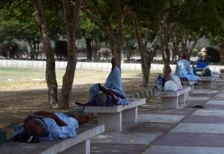 Pakistani men rest in the shade of trees during a heatwave in Karachi on June 23, 2015. Credit: Rizwan Tabassum/AFP via Getty Images