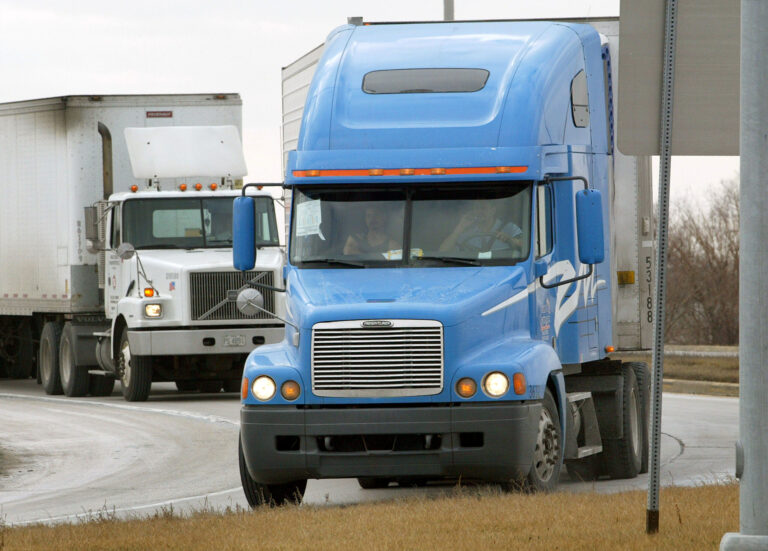 Tractor-trailers move along an interstate frontage road Jan. 13, 2004 in Hampshire, Illinois. Credit: Tim Boyle/Getty Images
