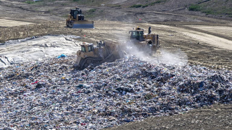 Trash is flattened and spread out across a hilllside before being covered with dirt at the Prima Deshecha landfill in San Juan Capistrano on Thursday, March 10, 2022. Credit: Mark Rightmire/MediaNews Group/Orange County Register via Getty Images