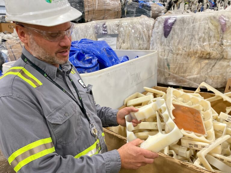 Jay Schabel, president of the plastics division at Brightmark, holds waste plastic from what he described as medical hip replacement parts at the company's new chemical recycling plant in northeast Indiana at the end of July. The plant is designed to turn plastic waste into diesel fuel, naphtha, and wax. Credit: James Bruggers