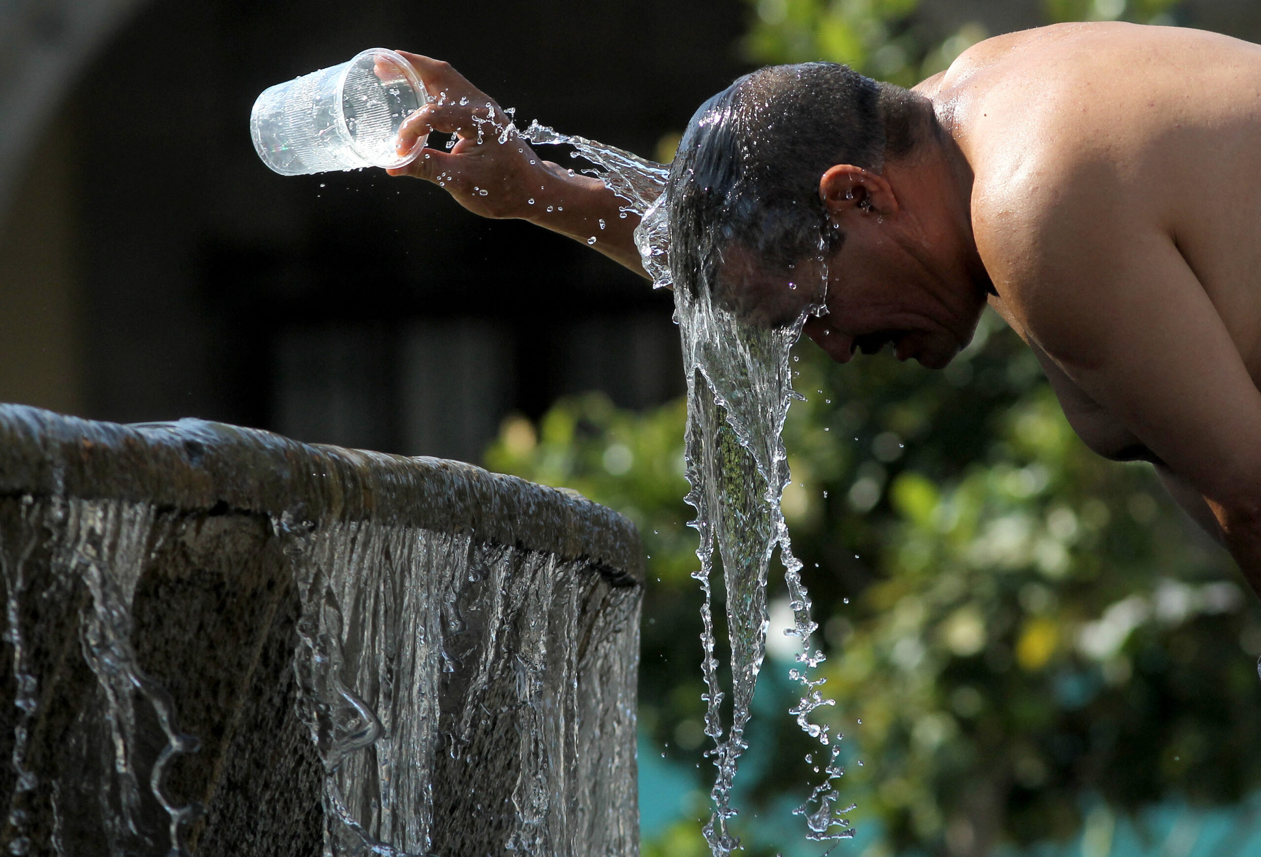 A man cools himself down with water from a water fountain during one of the hottest days of the third heat wave in Guadalajara, Jalisco state, Mexico, on June 12, 2023. Credit: Ulises Ruiz/AFP via Getty Images