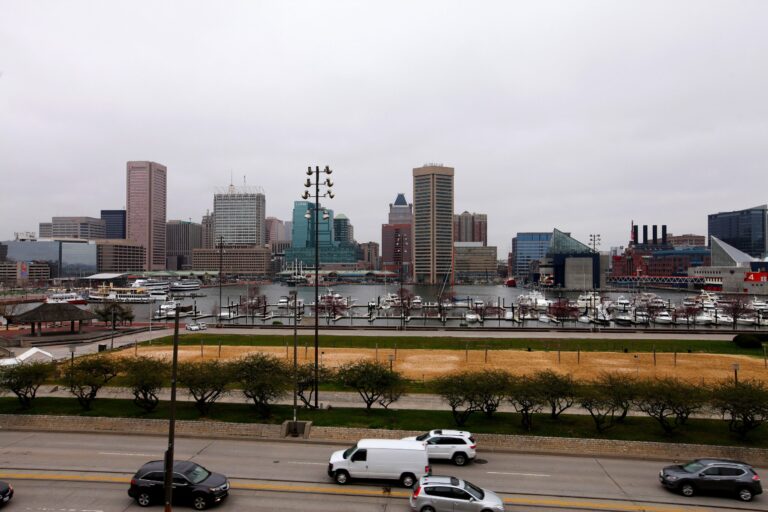 Polluting vehicles and the Baltimore skyline, from Federal Hill Park. Credit: Raymond Boyd/Getty Images.