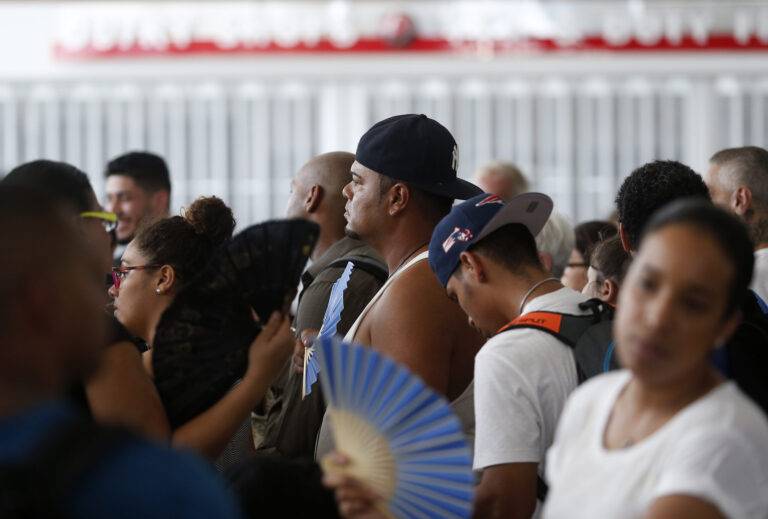 People wait in line for a flight out in a sweltering San Juan Airport in San Juan, Puerto Rico on Sept. 29, 2017. Credit: Jessica Rinaldi/The Boston Globe via Getty Images