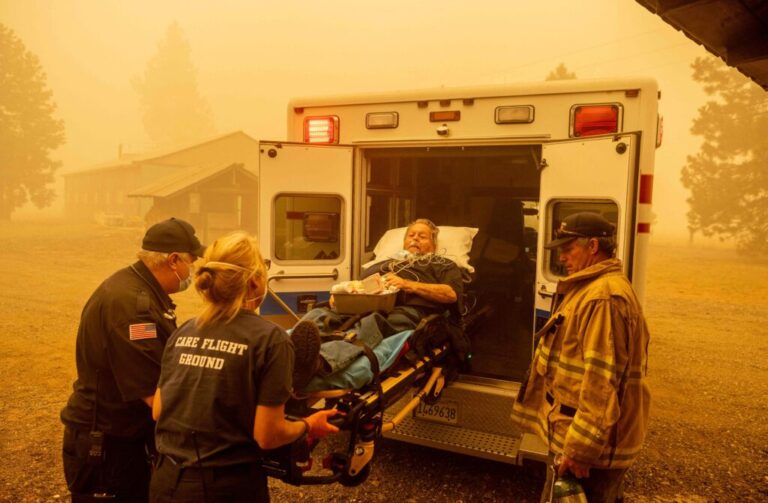 Don Crail, whose home burned down in the Dixie Fire, is rushed into an ambulance for a medical issue in Greenville, California in August 2021. Credit: Josh Edelson/AFP via Getty Images.