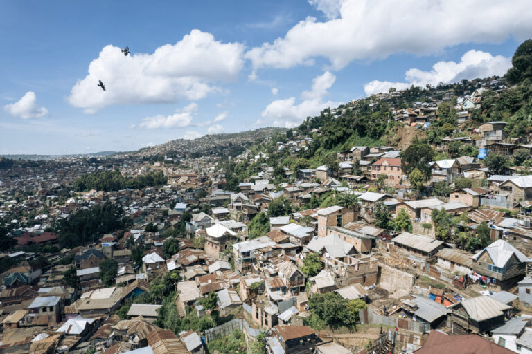 Shacks of planks and metal sheets and houses under construction in Nyakaliba, a poor neighborhood in Bukavu, eastern Democratic Republic of Congo, in May 2023. The country is currently facing claims through the investor-state dispute settlements process, or ISDS, from three foreign mining companies seeking more than $30 billion, twice Congo's gross domestic product. Credit: Alexis Huguet/AFP via Getty Images.