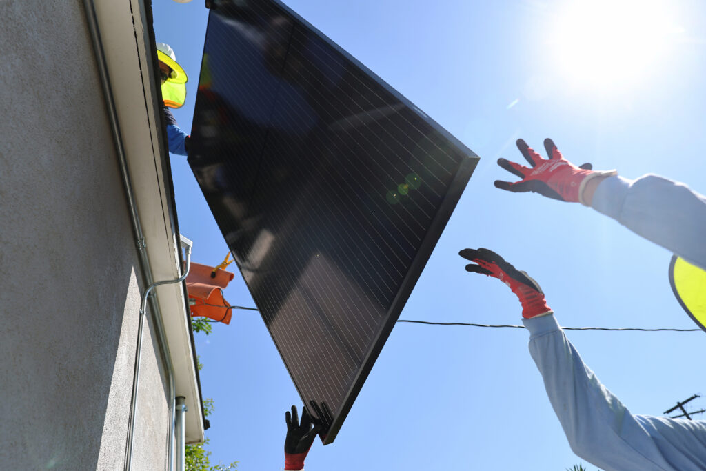 GRID Alternatives employees install no-cost solar panels on the rooftop of a low-income household on Oct. 19, 2023 in Pomona, Calif. Credit: Mario Tama/Getty Images