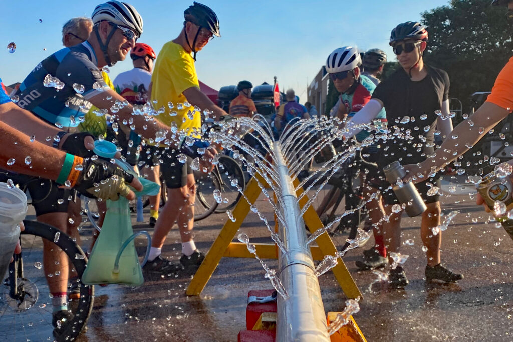 Cyclists stop at a water station along the RAGBRAI route in Iowa. Credit: Len Radin/CC BY-NC-SA 2.0