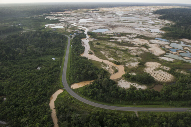The Interoceanic Highway runs by an illegal gold mining site in La Pampa, Peru. Credit: Ernesto Benavides/AFP via Getty Images