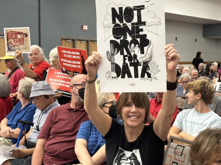 At the Tucson Convention Center in August 2025, demonstrators opposed "Project Blue," a massive data center installation proposed by Amazon Web Services. Data centers have also now become a flashpoint in Phoenix, the third largest data center market in the country. Across the state, ratepayers are linking data center development to higher electric bills. Credit: Wild Horizons/Universal Images Group via Getty Images
