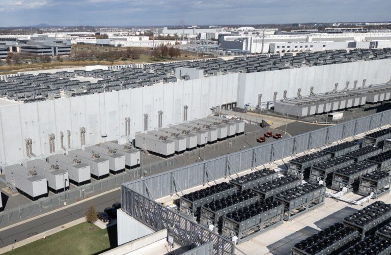 An aerial view shows cooling vent fans on the roof next to generators on the lower level of a Digital Realty data center in Ashburn, Virginia, in November 2025. Credit: Andrew Caballero-Reynolds/AFP via Getty Images