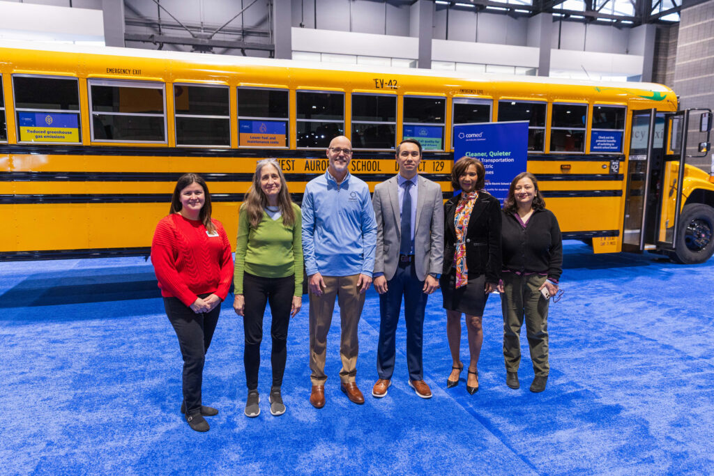 Speakers at the ComEd press conference pose in front of an electric school bus during the Chicago Auto Show media preview day on Feb. 6. Credit: Courtesy of ComEd