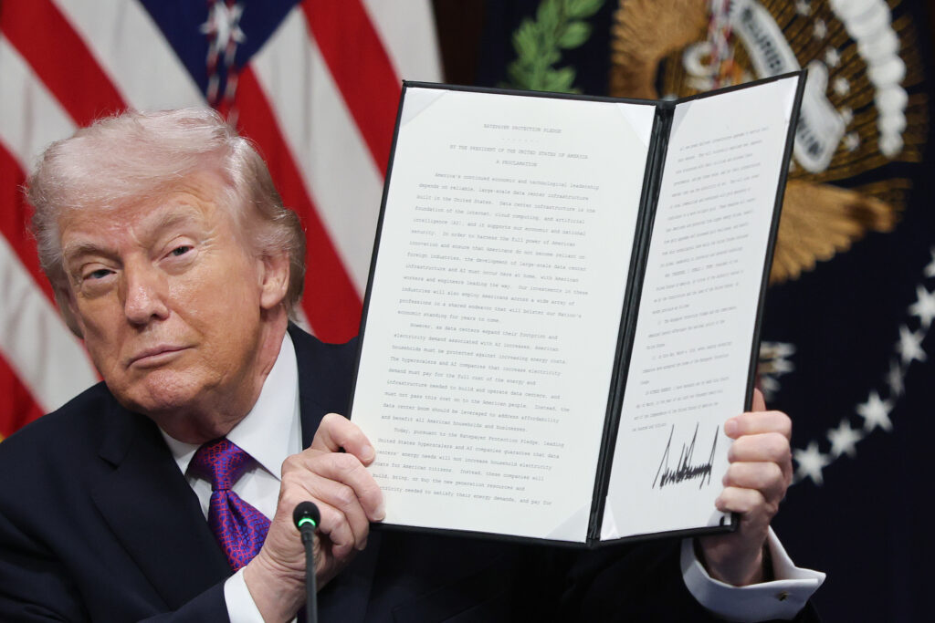 President Donald Trump holds up the Ratepayer Protection Pledge after signing it during a roundtable meeting at the White House on Wednesday. Credit: Win McNamee/Getty Images