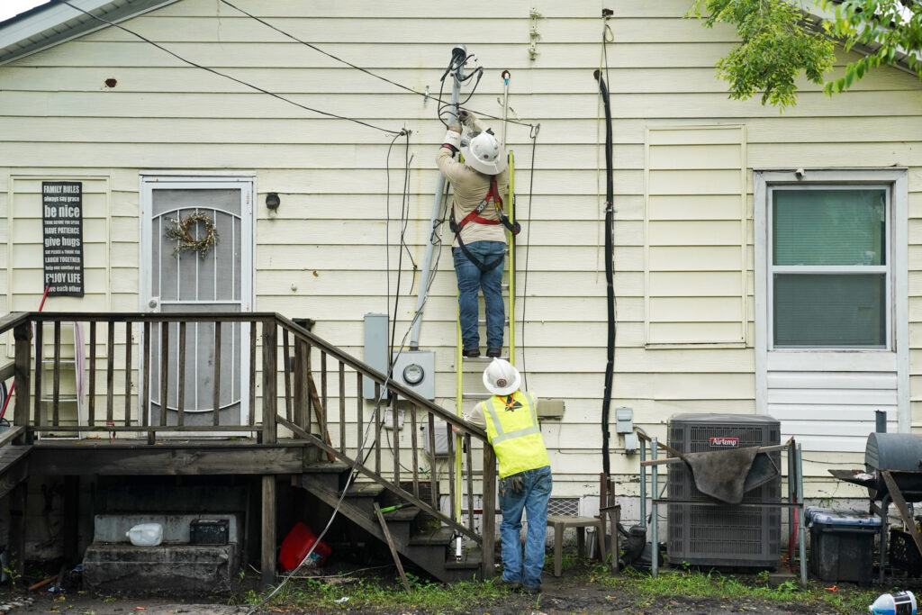 Power line crews with Georgia Power work at a home in Savannah on Aug. 6, 2024. Credit: Megan Varner/Getty Images
