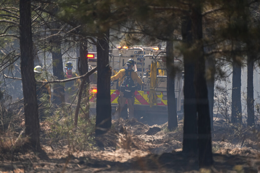 Crews work in the forest at the site of the Spring Pine Fire near Bastrop State Park on Monday in Bastrop, Texas. Credit: Aaron E. Martinez/The Austin American-Statesman via Getty Images