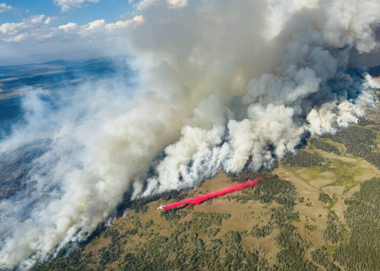 An air tanker works to slow the spread of the Dollar Lake Fire as it burns through Wyoming in August 2025. Credit: Kris Bruington/BLM