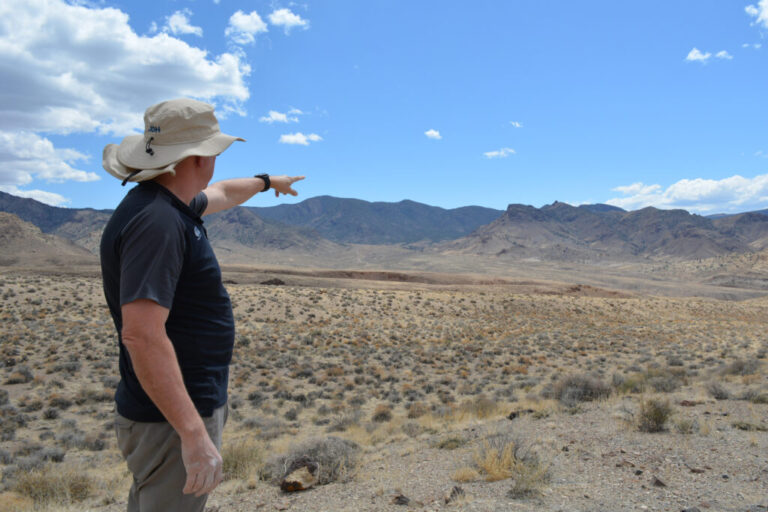 Bernard Rowe, managing director of Ioneer, points to the site of the company’s planned lithium mine on Nevada’s Rhyolite Ridge. Credit: Wyatt Myskow/Inside Climate News