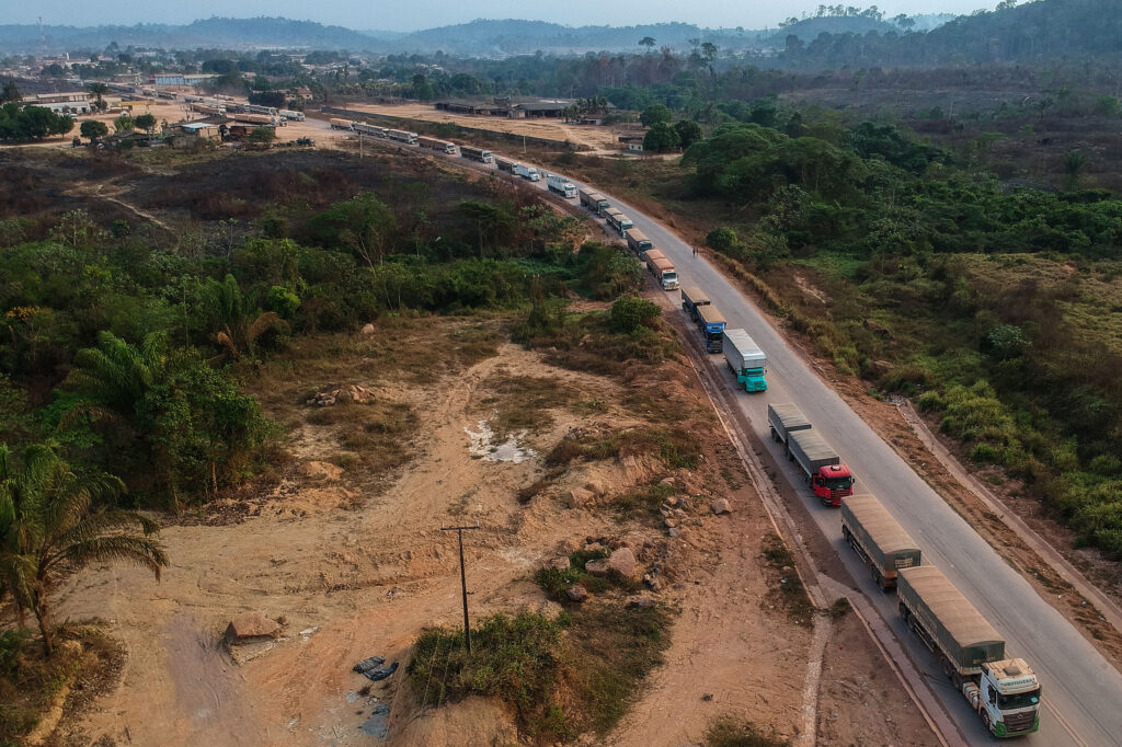 Trucks drive along the BR-163 highway through the Amazon rainforest in Pará, Brazil. Credit: Nelson Almeida/AFP via Getty Images