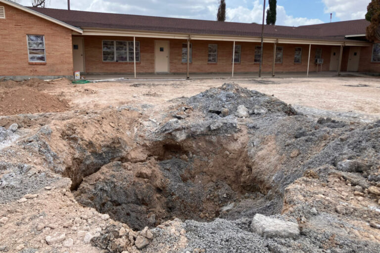 A pit in the parking lot of the First Baptist Church in Grandfalls, Texas, where the Railroad Commission plugged a wellbore that was previously gushing thousands of gallons of wastewater a minute. Credit: Martha Pskowski/Inside Climate News
