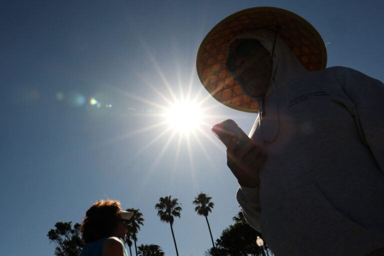 A person wears a hat for shade during a heat wave on March 20 in Redondo Beach, Calif. The March heat wave that blistered the Western U.S. foreshadows more extreme heat this summer, former NOAA climate scientists said in a briefing this week. Credit: Patrick T. Fallon/AFP via Getty Images